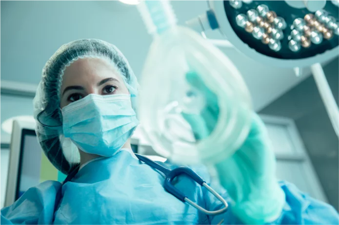 A surgeon applying a medical device for breathing